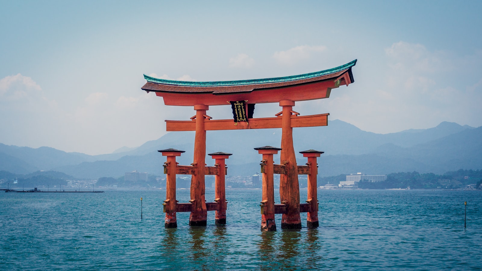水辺に立つ赤い鳥居のある日本の観光地